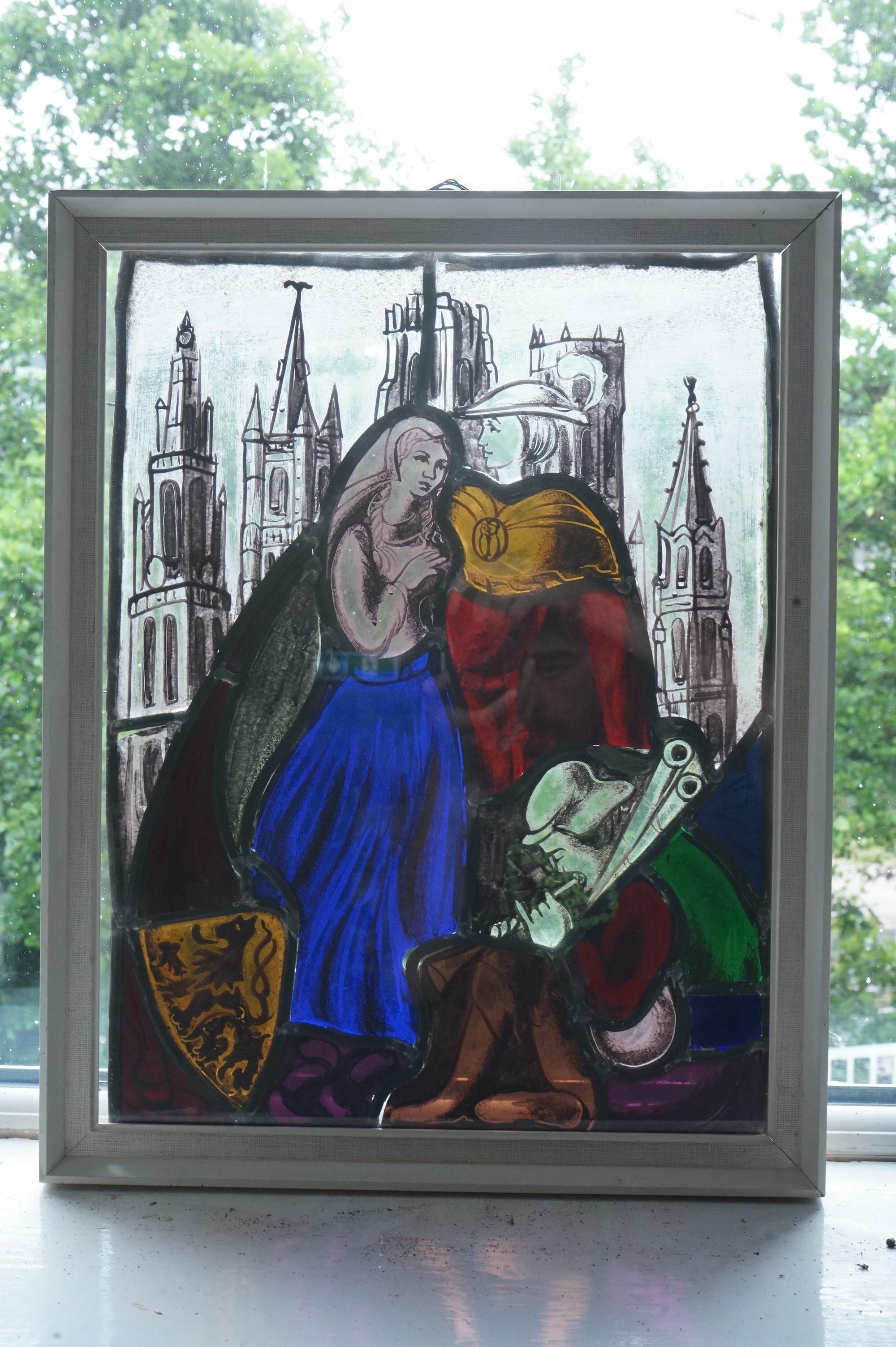 A stained and leaded glass panel of a romantic couple in front of a cathedral, 48cm high